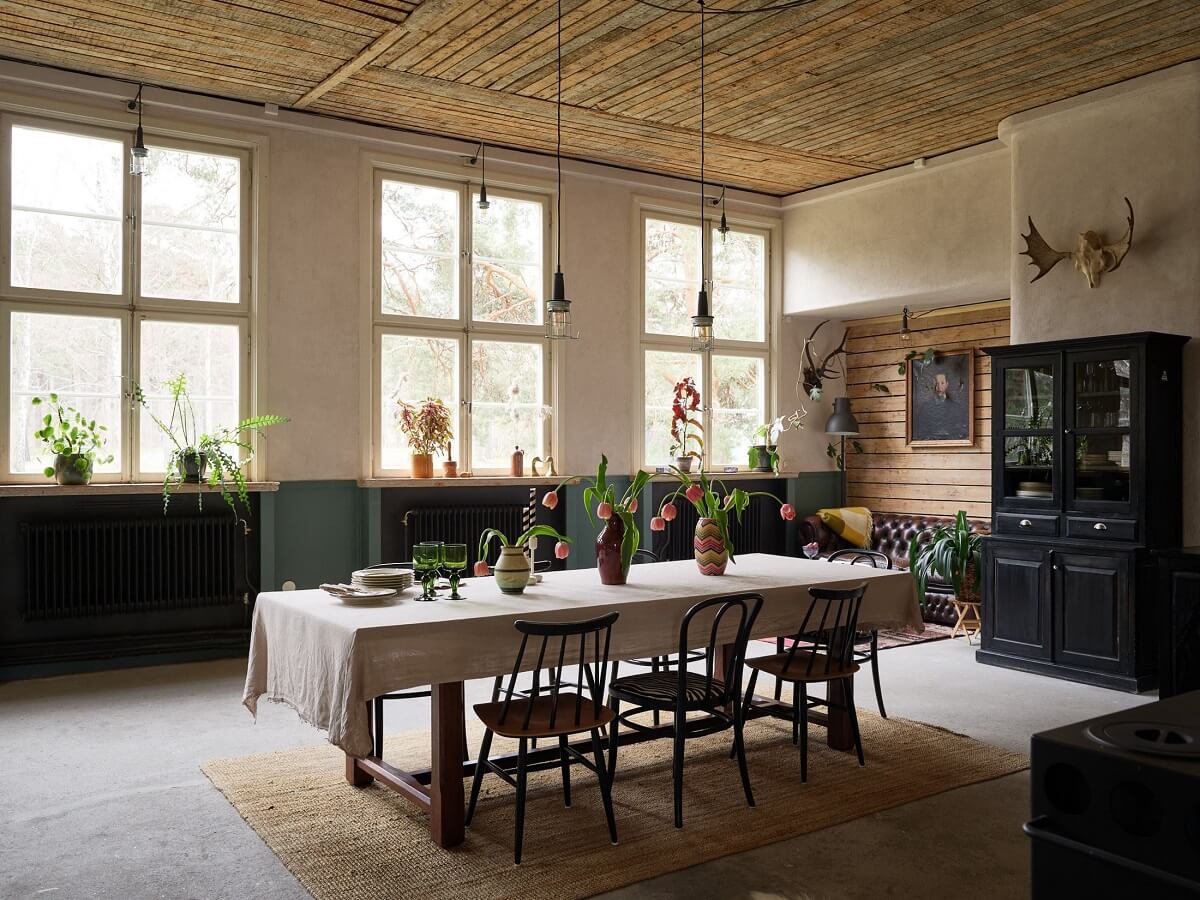 A Charming School Conversion in Sweden 2 large dining table and wooden ceiling in school conversion