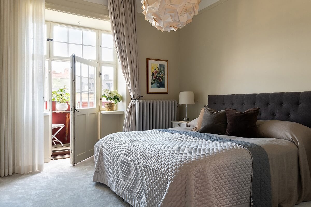 An Elegant Turn-of-the-Century Apartment in Stockholm 23 light gray bedroom with balcony