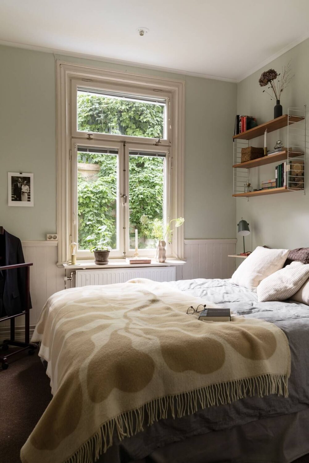 A Swedish Duplex with a Unique Wood and Pastel Colored Kitchen 15 light gray bedroom with shelves