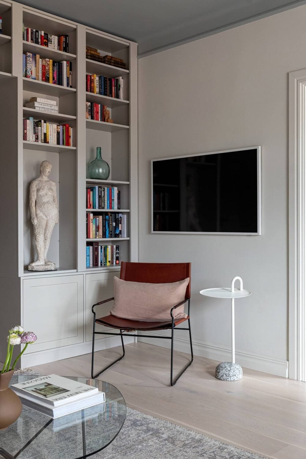 A Stylish Renovated Stockholm Apartment with Built-In Storage 3 light gray living room with bookshelves