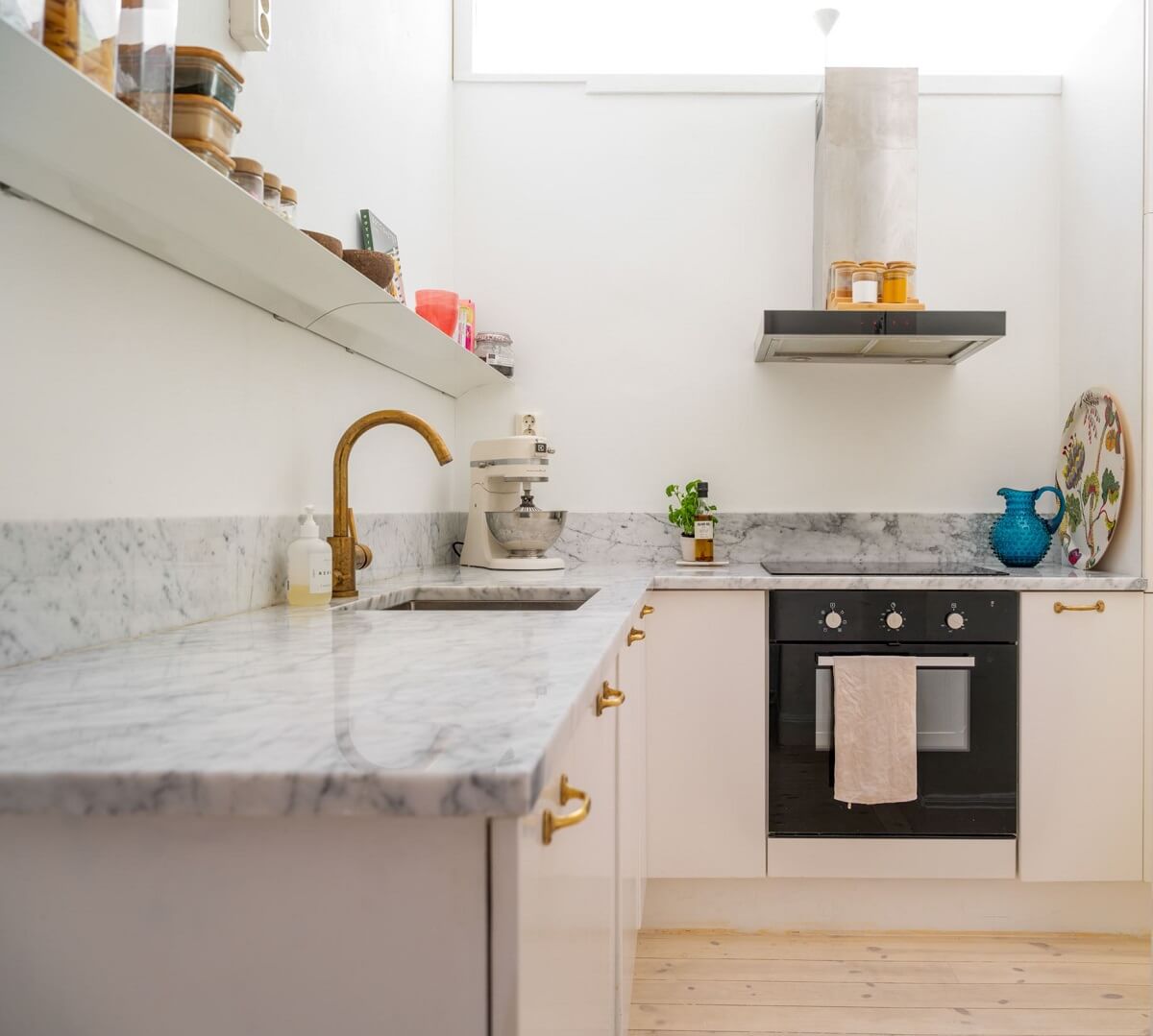 A Small, Tastefully Renovated Apartment in Stockholm 11 light kitchen marble worktop brass fittings
