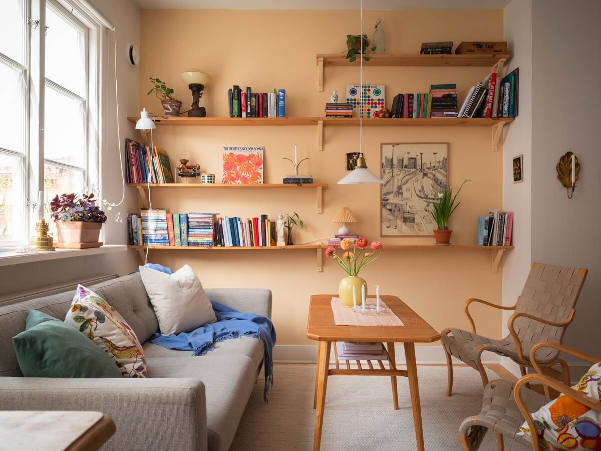 Warm Orange Tones in a Small Apartment 2 living room light orange tone wall