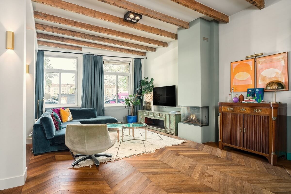 A Colorful Family Home with Open-Plan Spaces in Amsterdam 10 living room with blue accents chevron floor and wooden ceiling beams