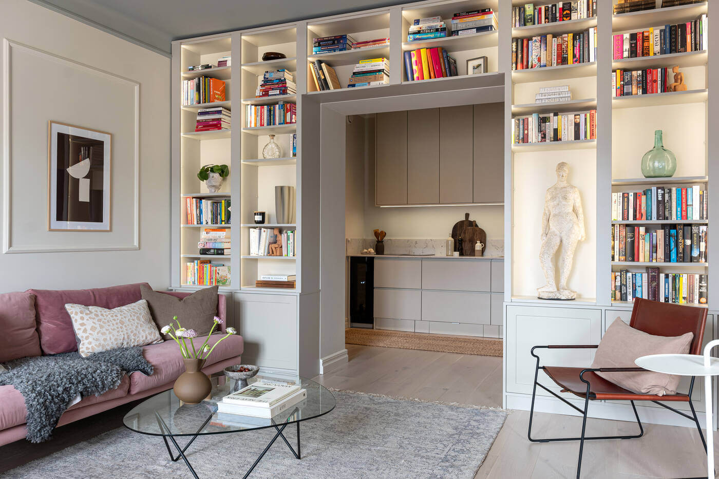 A Stylish Renovated Stockholm Apartment with Built-In Storage 2 living room with bookshelves and painted ceiling