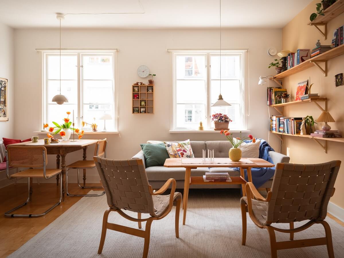Warm Orange Tones in a Small Apartment 1 living room with dining space and light orange wall