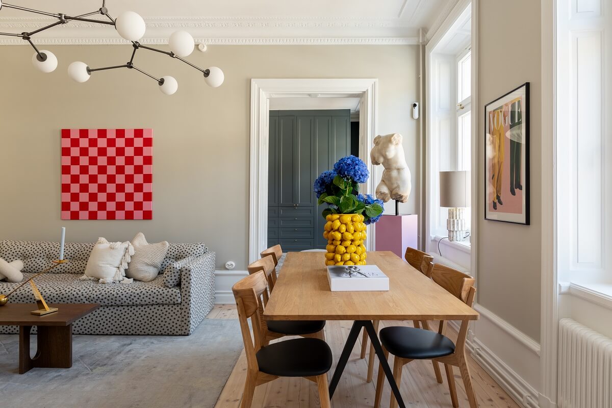 A Light Renovated Apartment in Stockholm 2 living room with dining table and color accents nordroom