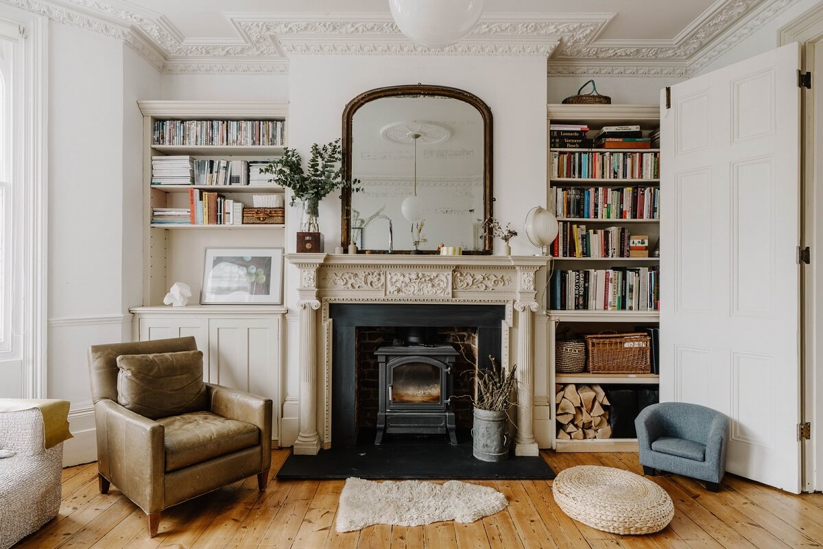 Neutral Tones and Original Features in an English Townhouse 7 living room with fireplace flanked by bookshelves