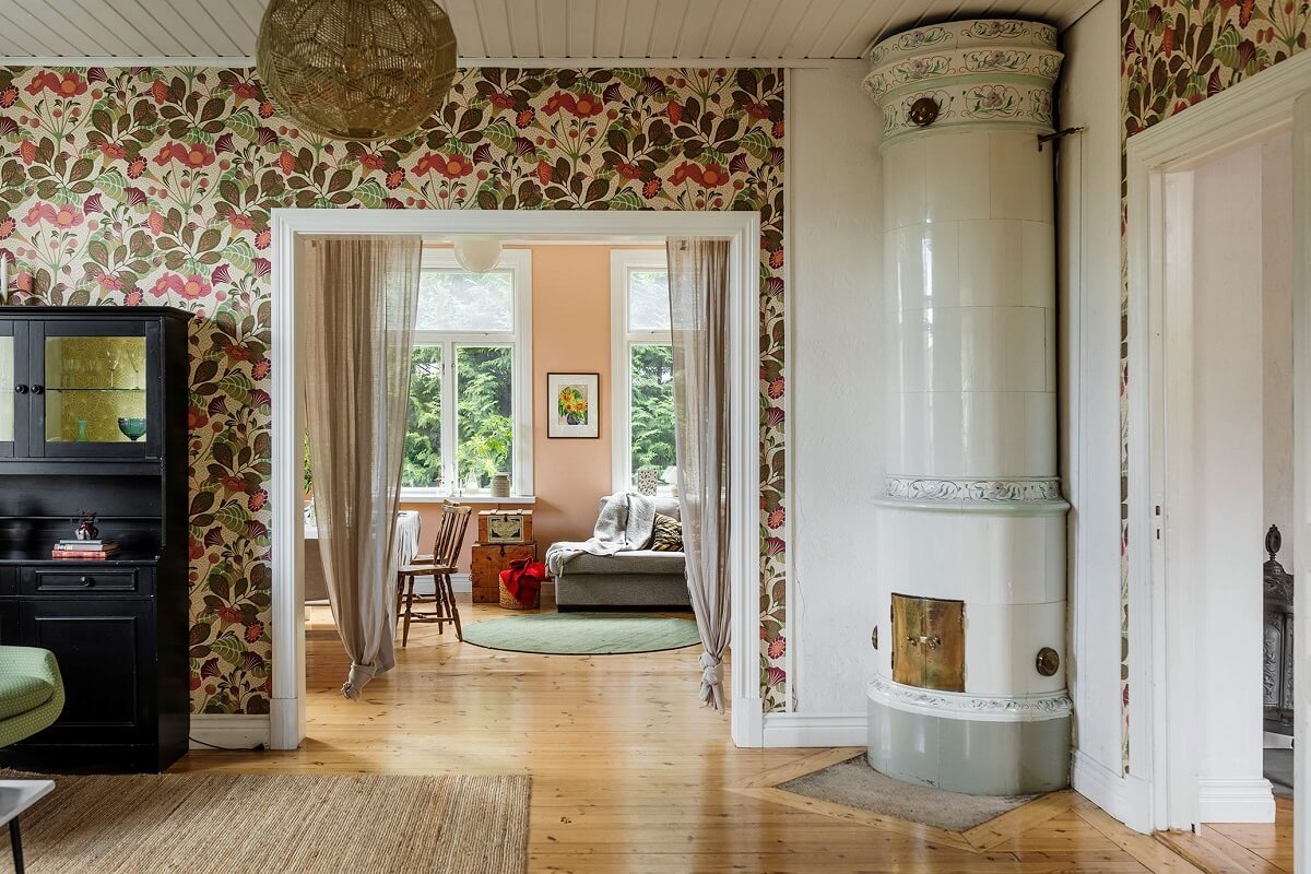 A Historic Swedish Country House with a Beautiful Garden 5 living room with floral wallpaper and fireplace