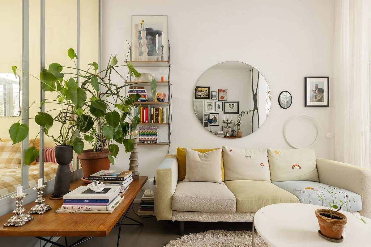 A Unique Basement Apartment in Stockholm 3 living room with large round mirror nordroom