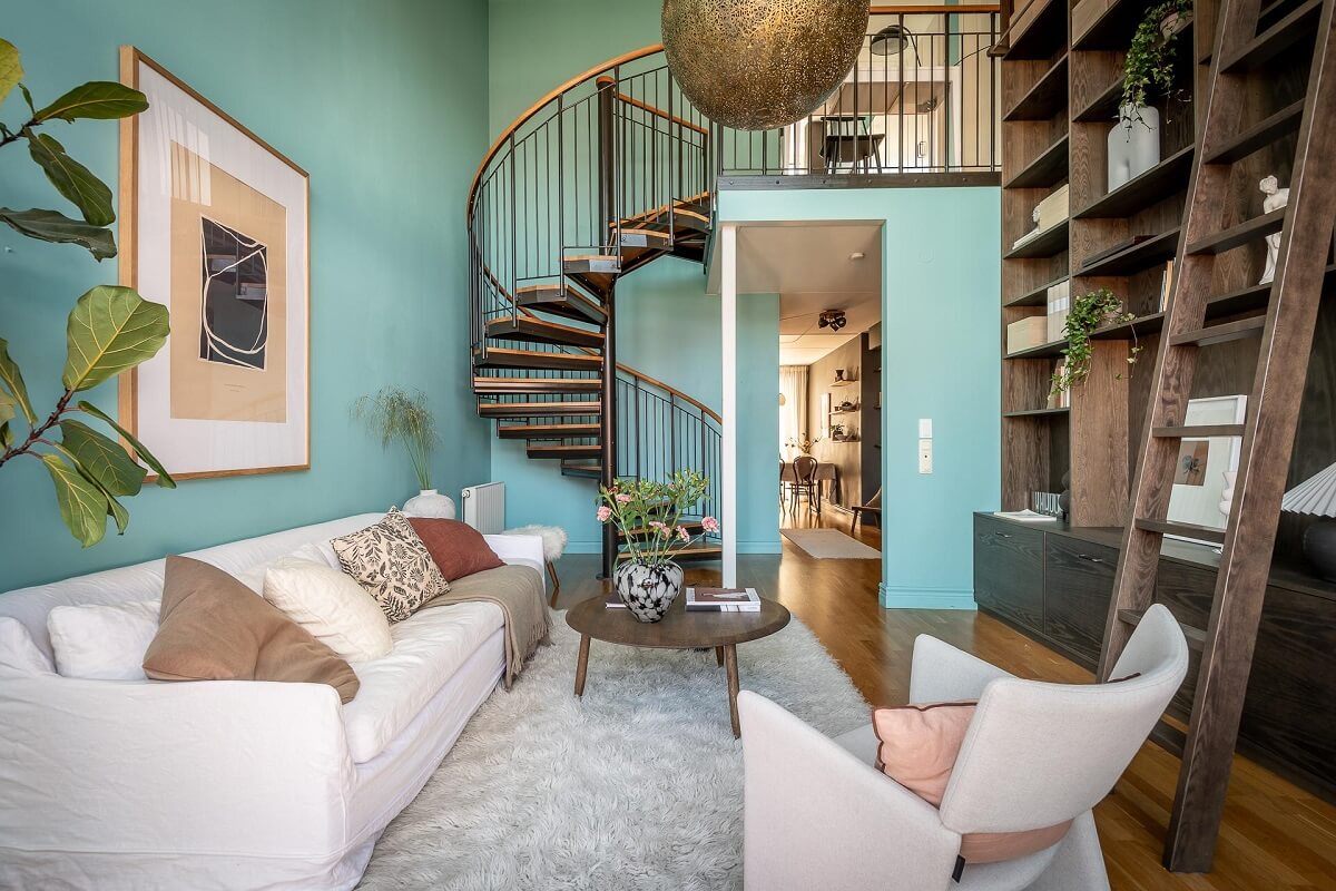 Floor-to-Ceiling Bookcases and Windows in a Loft Style Apartment 7 living room with light blue walls and floor to ceiling bookcases nordroom