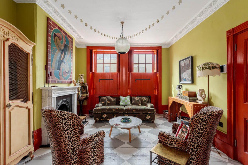 Unique Color Combinations and Design in a London Townhouse 1 living room with painted checkerboard floor and red garage doors
