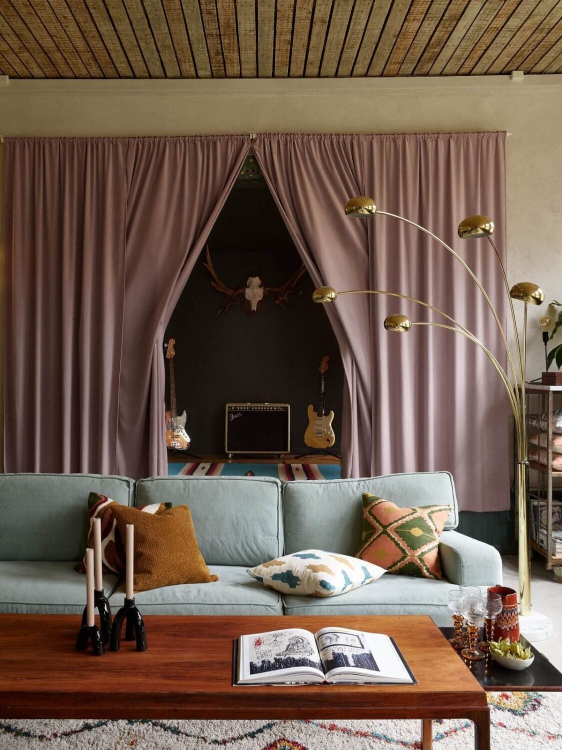 A Charming School Conversion in Sweden 12 living room with stage behind purple curtain