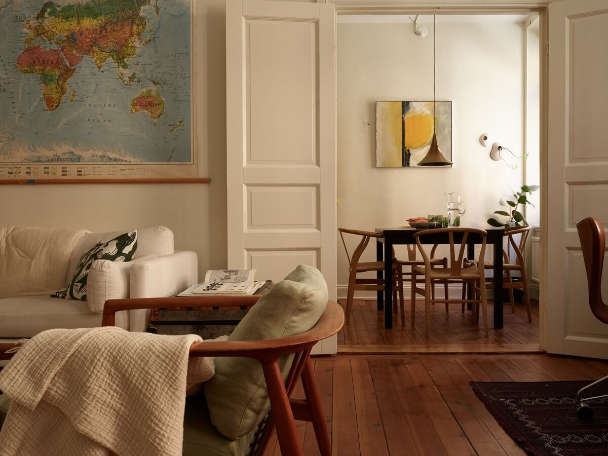 Warm Tones and a Blue Hallway in a Stockholm Apartment 6 living room with warm wooden floor