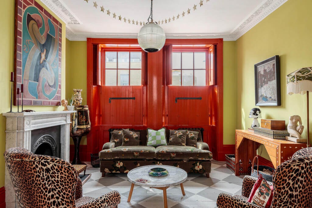 Unique Color Combinations and Design in a London Townhouse 3 living room with yellow walls and red garage doors