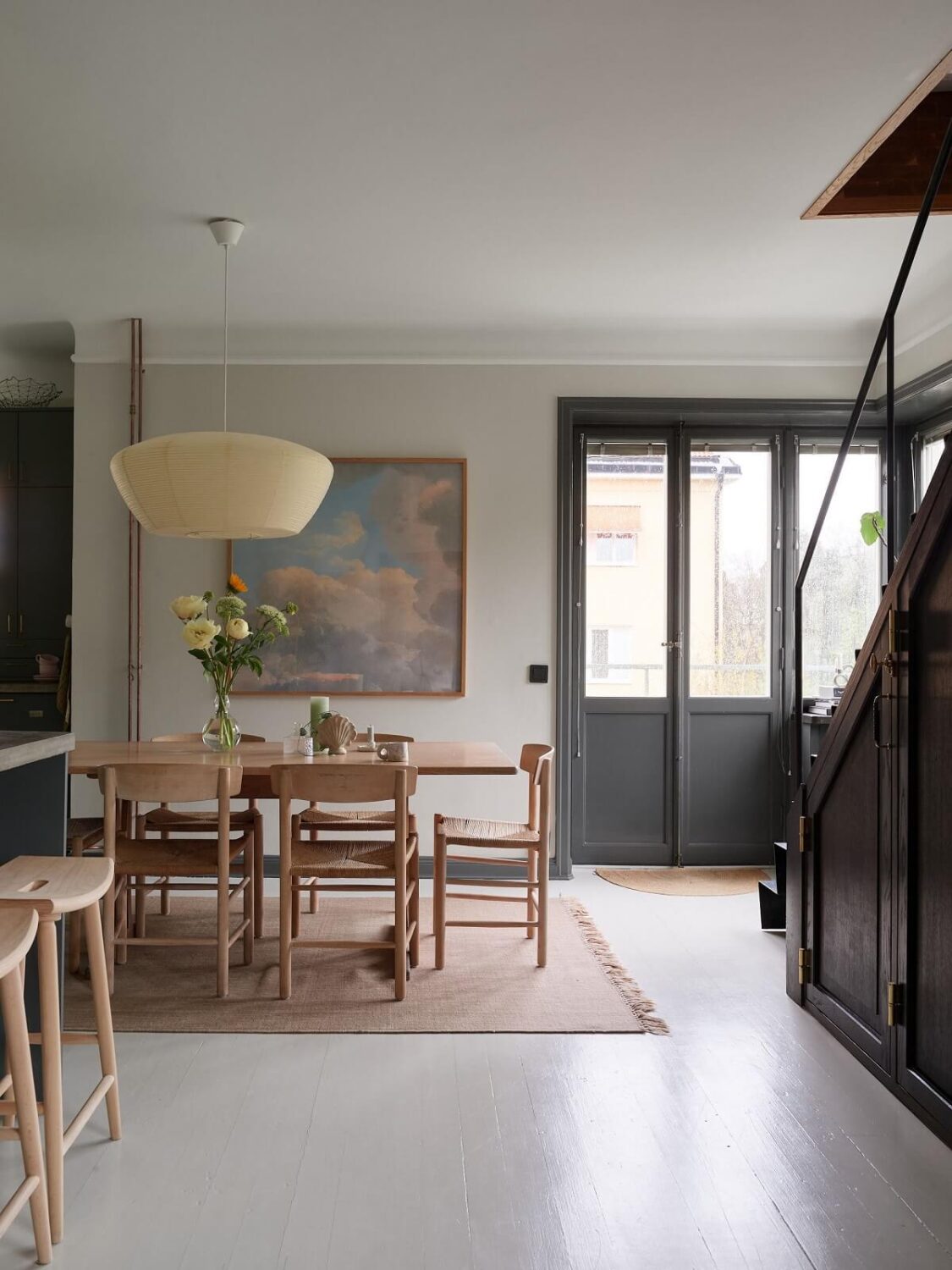 A Stunning Bathroom in a Duplex Apartment in Stockholm 5 living space with stairs and dining table