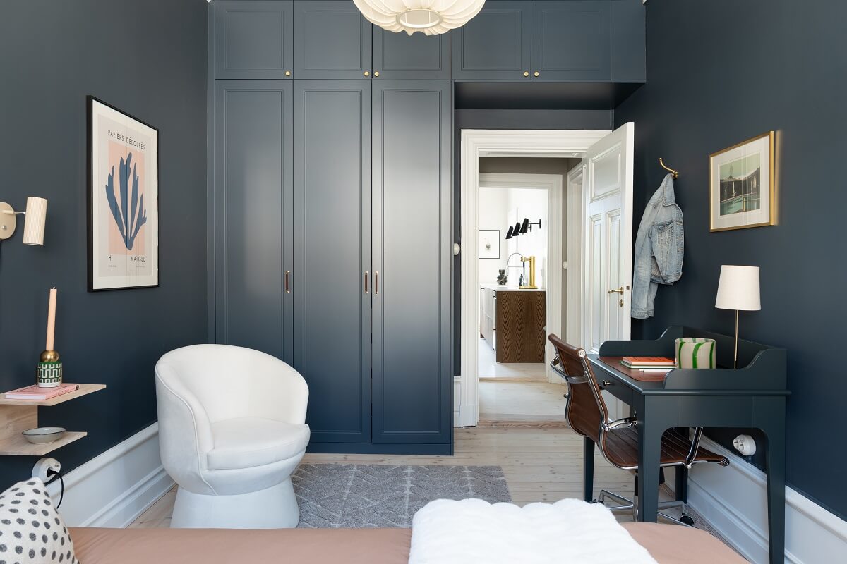 A Light Renovated Apartment in Stockholm 17 moody bedroom with built in wardrobes