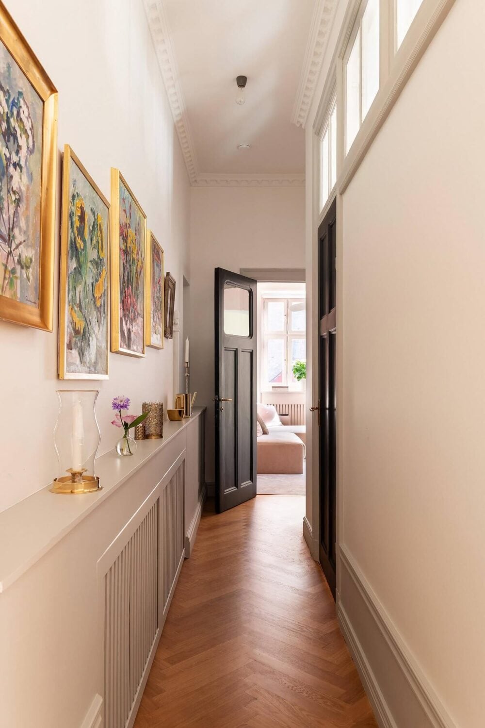 An Elegant Turn-of-the-Century Apartment in Stockholm 17 narrow hallway with wooden floor and storage ledge nordroom