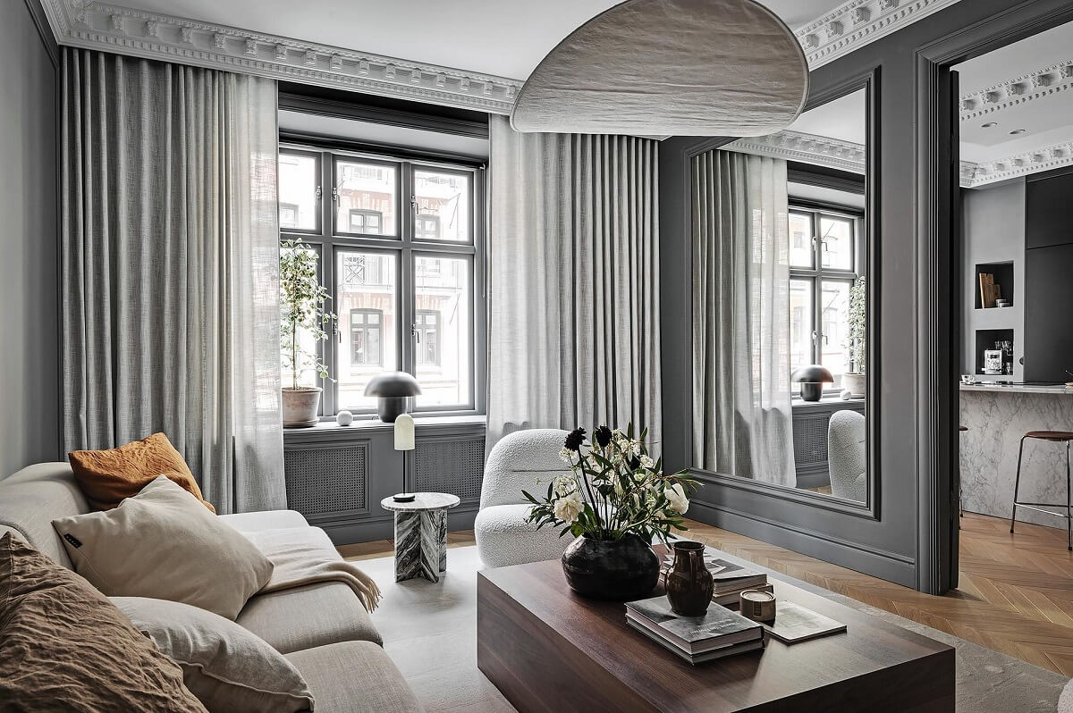 A Luxurious Renovated Apartment with Dark Gray Walls 3 nordic living room with gray walls large mirror