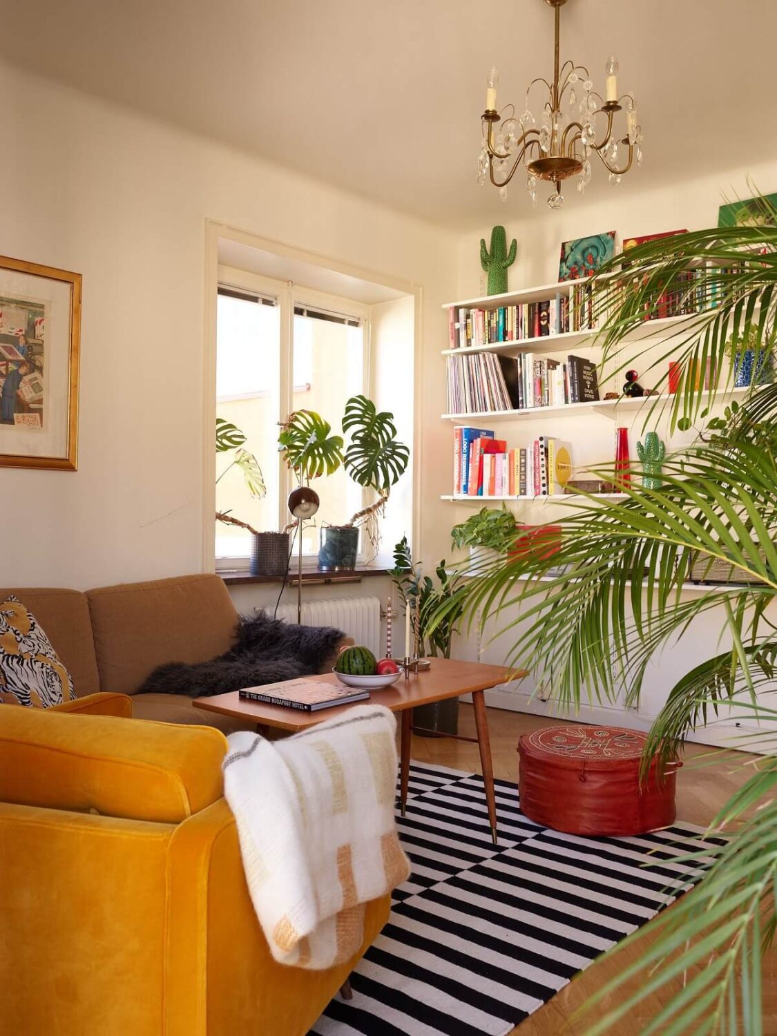 A Vintage Apartment with a Vibrant Blue Bedroom 3 ochre yellow chair and striped rug in midcentury living room
