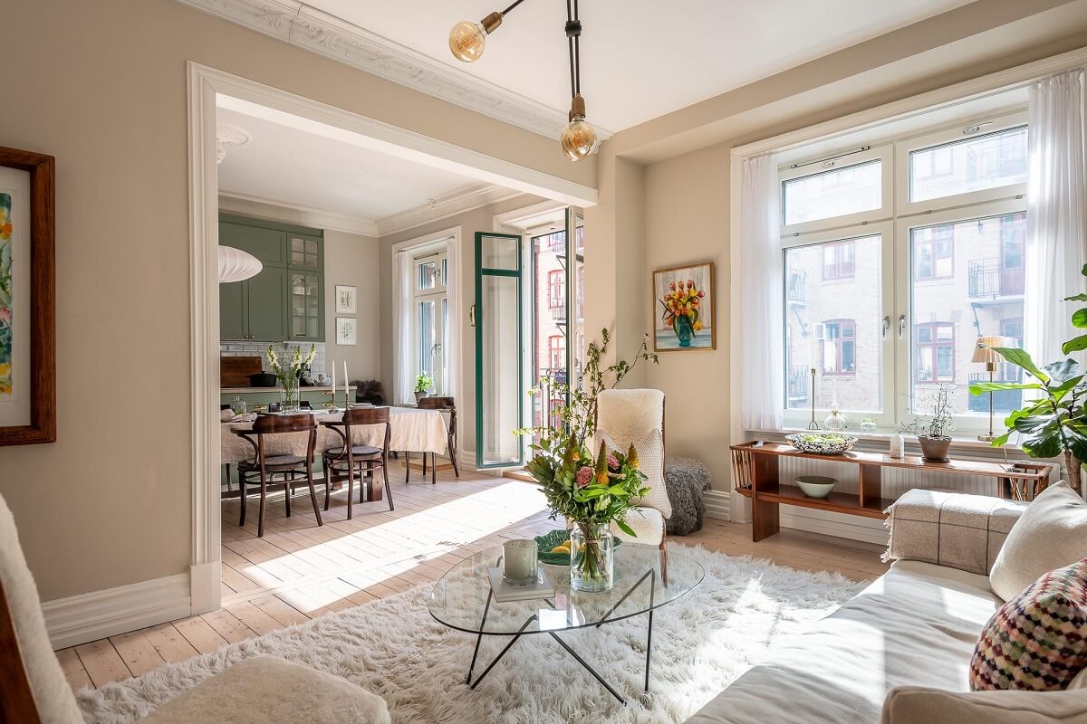 A Turn of the Century Apartment with a Green Kitchen 5 open plan living room with natural light