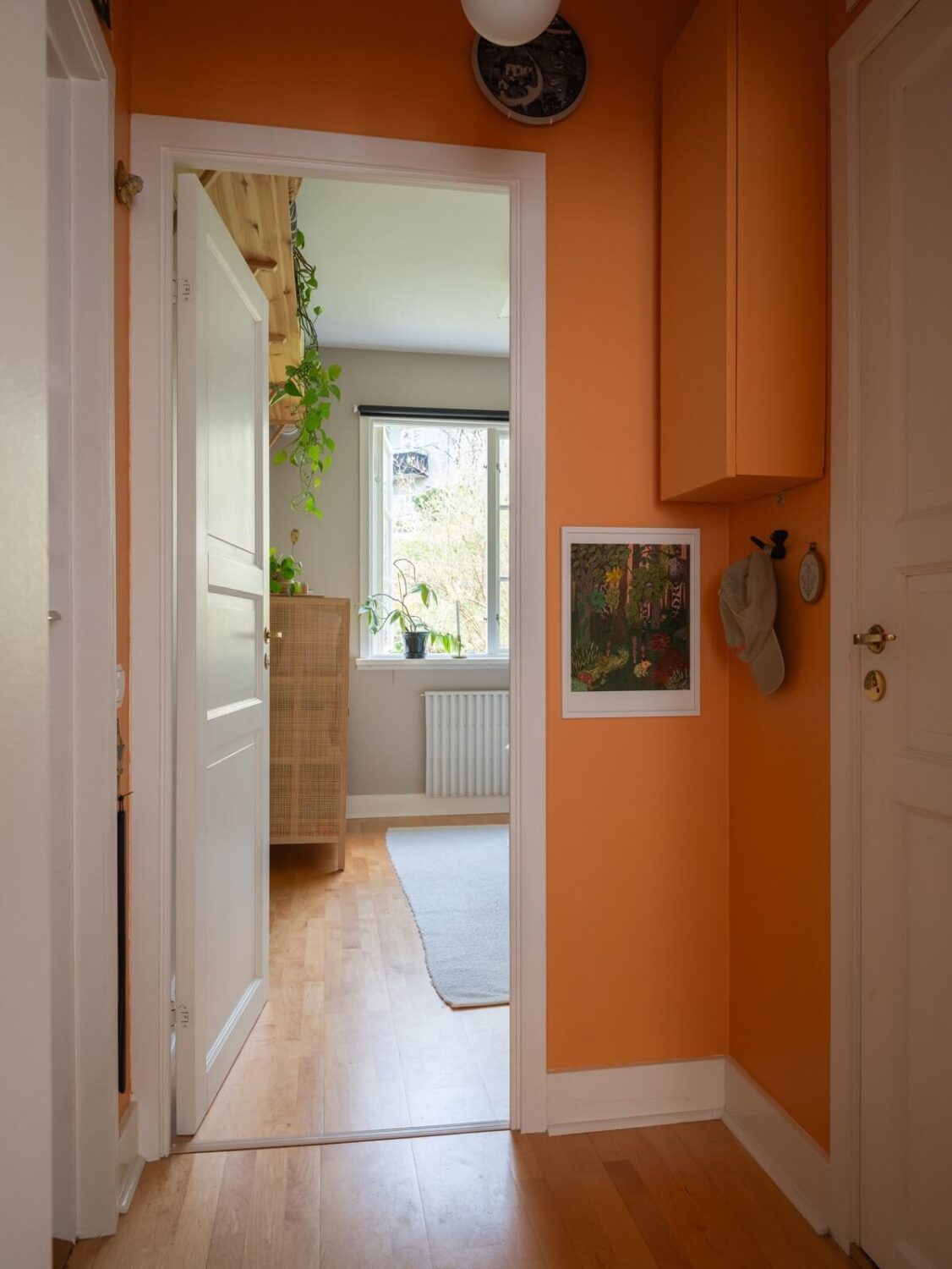 Warm Orange Tones in a Small Apartment 10 orange hallway