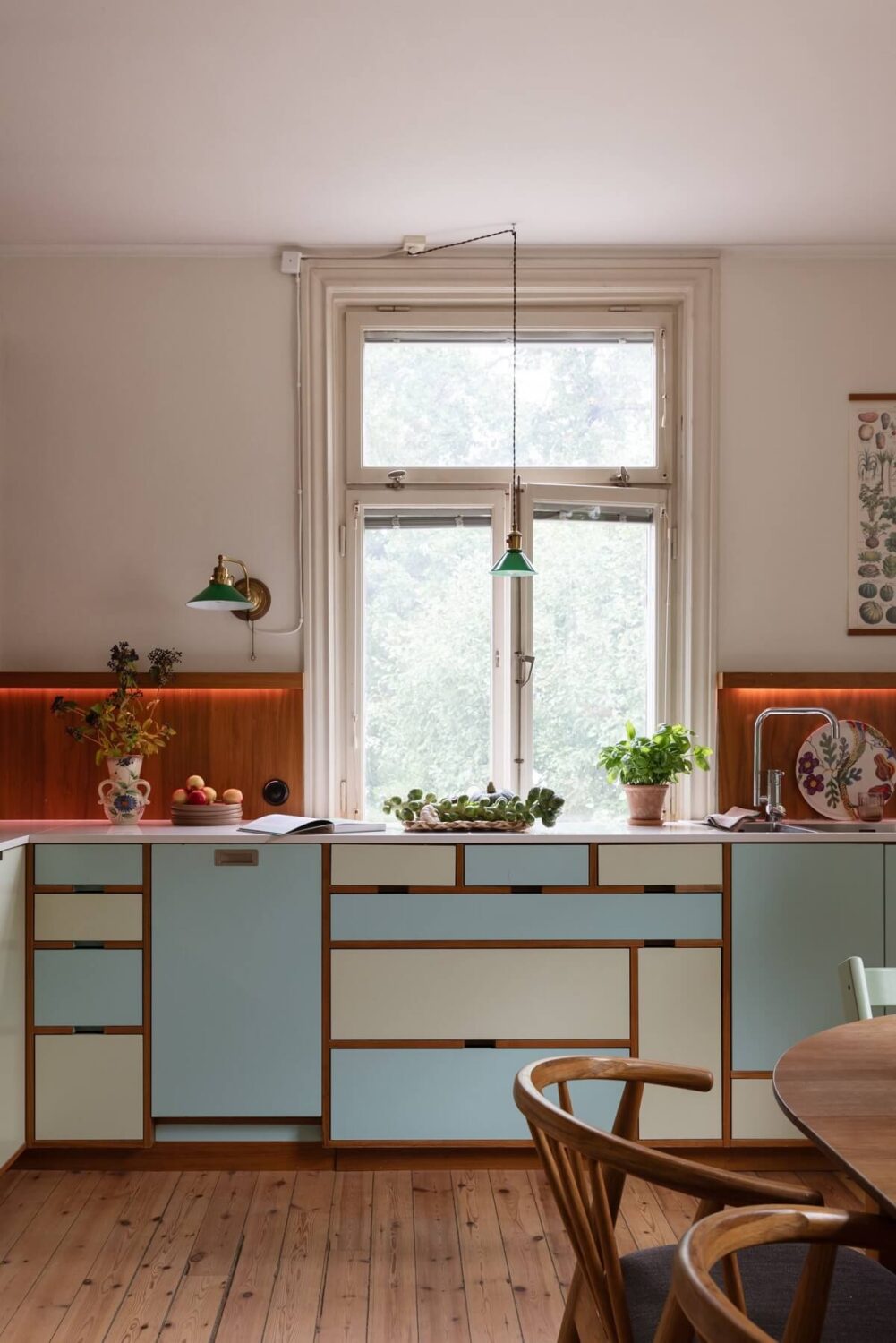 A Swedish Duplex with a Unique Wood and Pastel Colored Kitchen 3 pastel kitchen cabinets with wooden backsplash