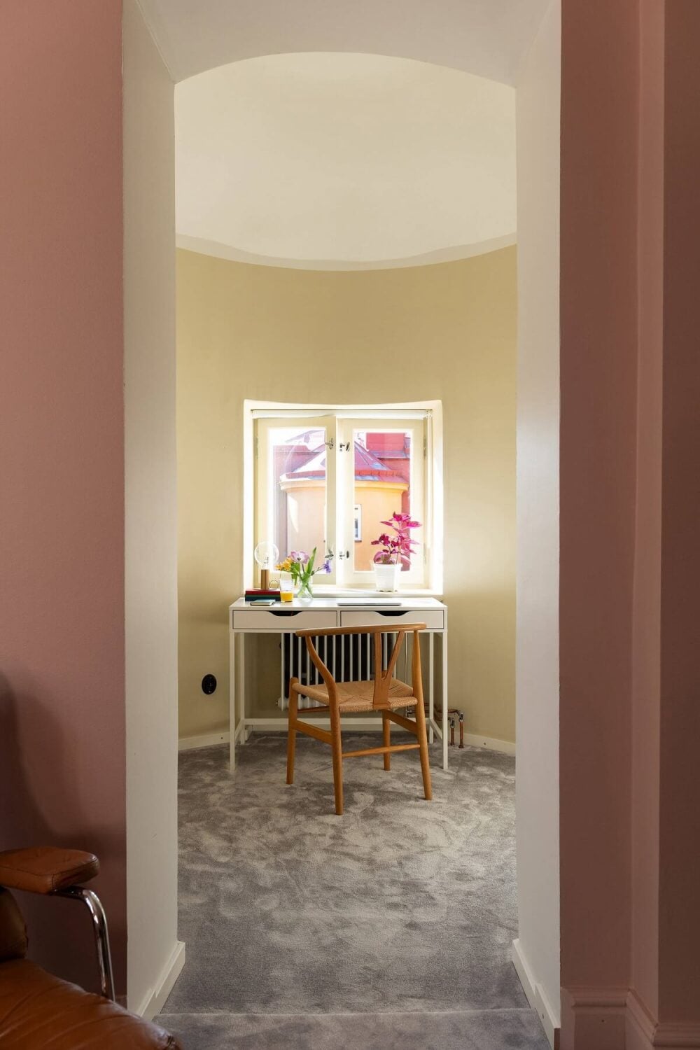 An Elegant Turn-of-the-Century Apartment in Stockholm 21 pastel yellow walls in round room home office nordroom