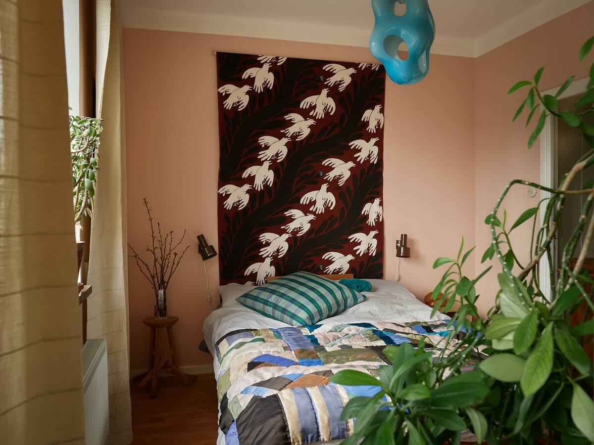 A Swedish Apartment with a Restored Original Kitchen 14 pink bedroom with plants