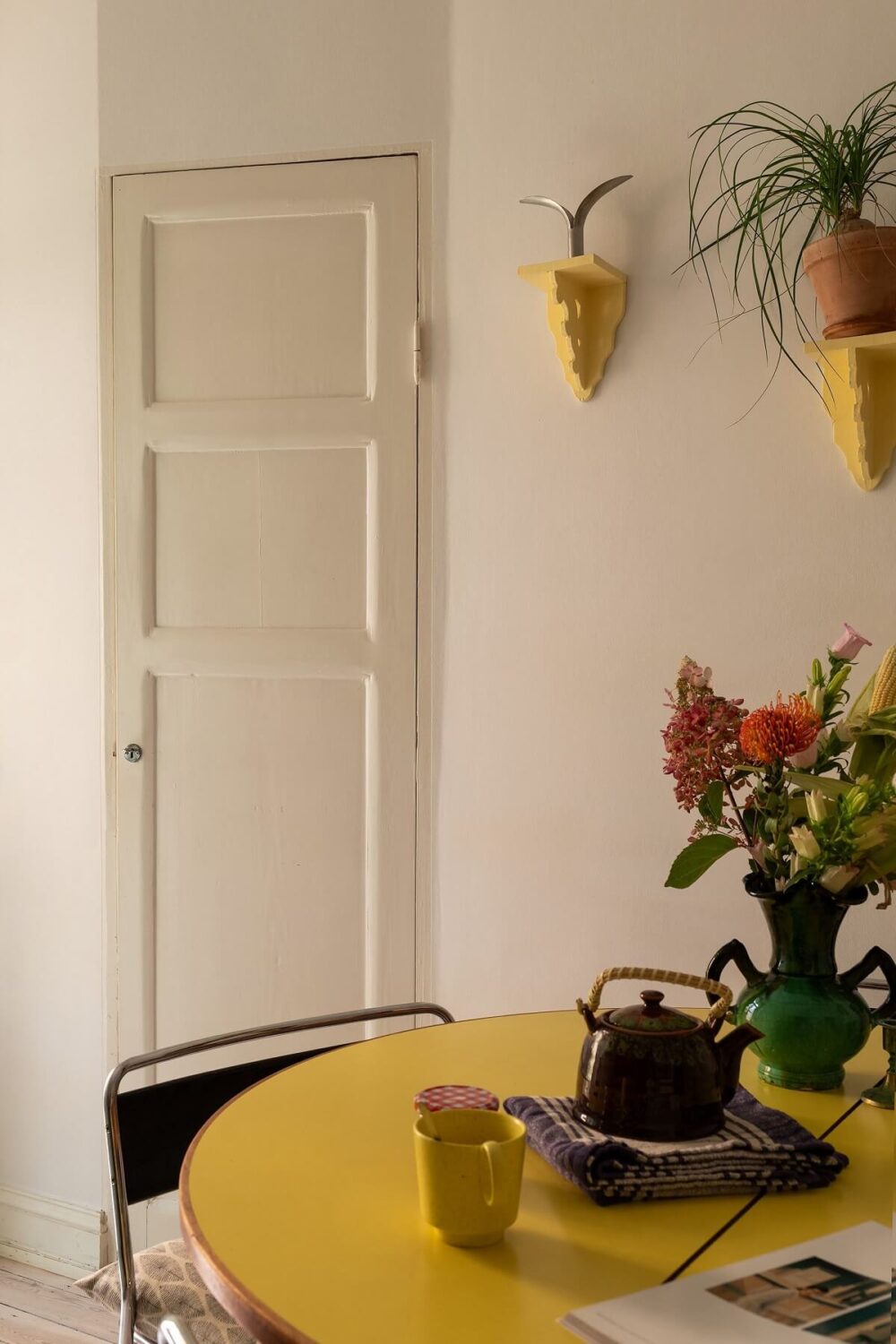 A Swedish Apartment with a Yellow Kitchen 7 round yellow kitchen table