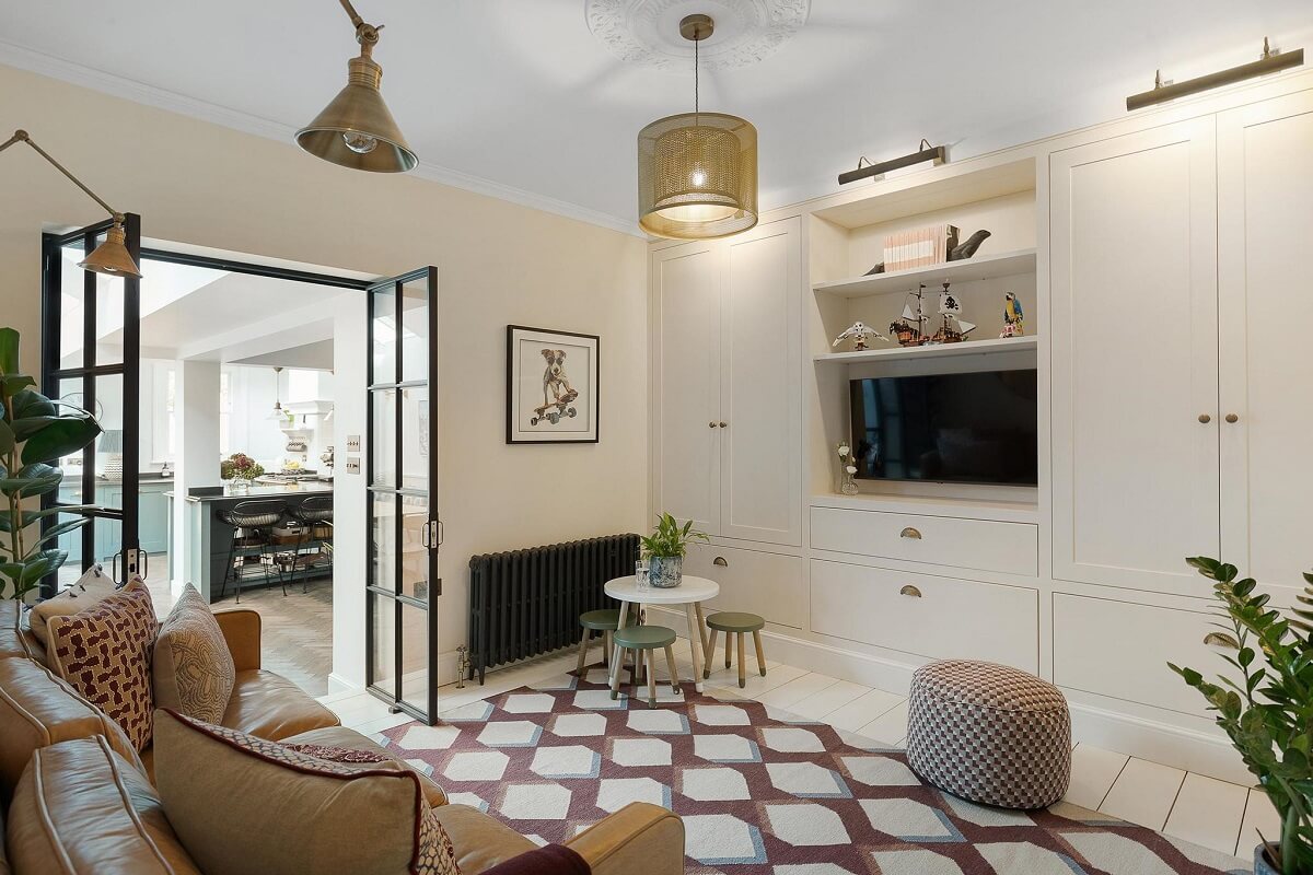 A Victorian House with a Blue deVOL Kitchen 7 sitting room with built in cabinets