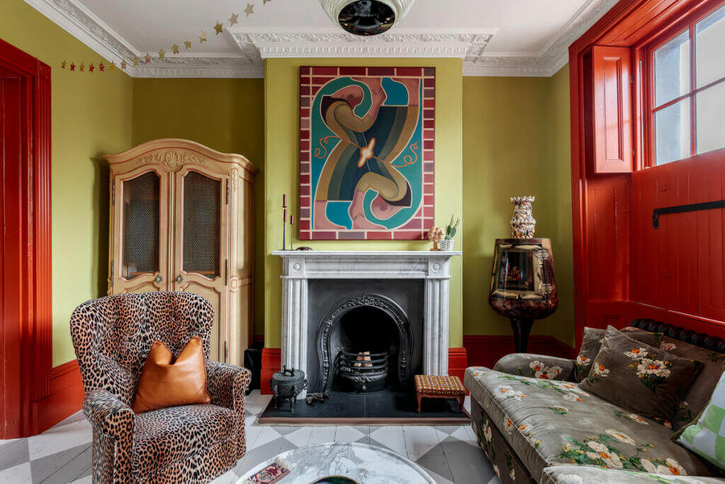 Unique Color Combinations and Design in a London Townhouse 2 sitting room with green walls fireplace and wooden floor with checkerboard pattern