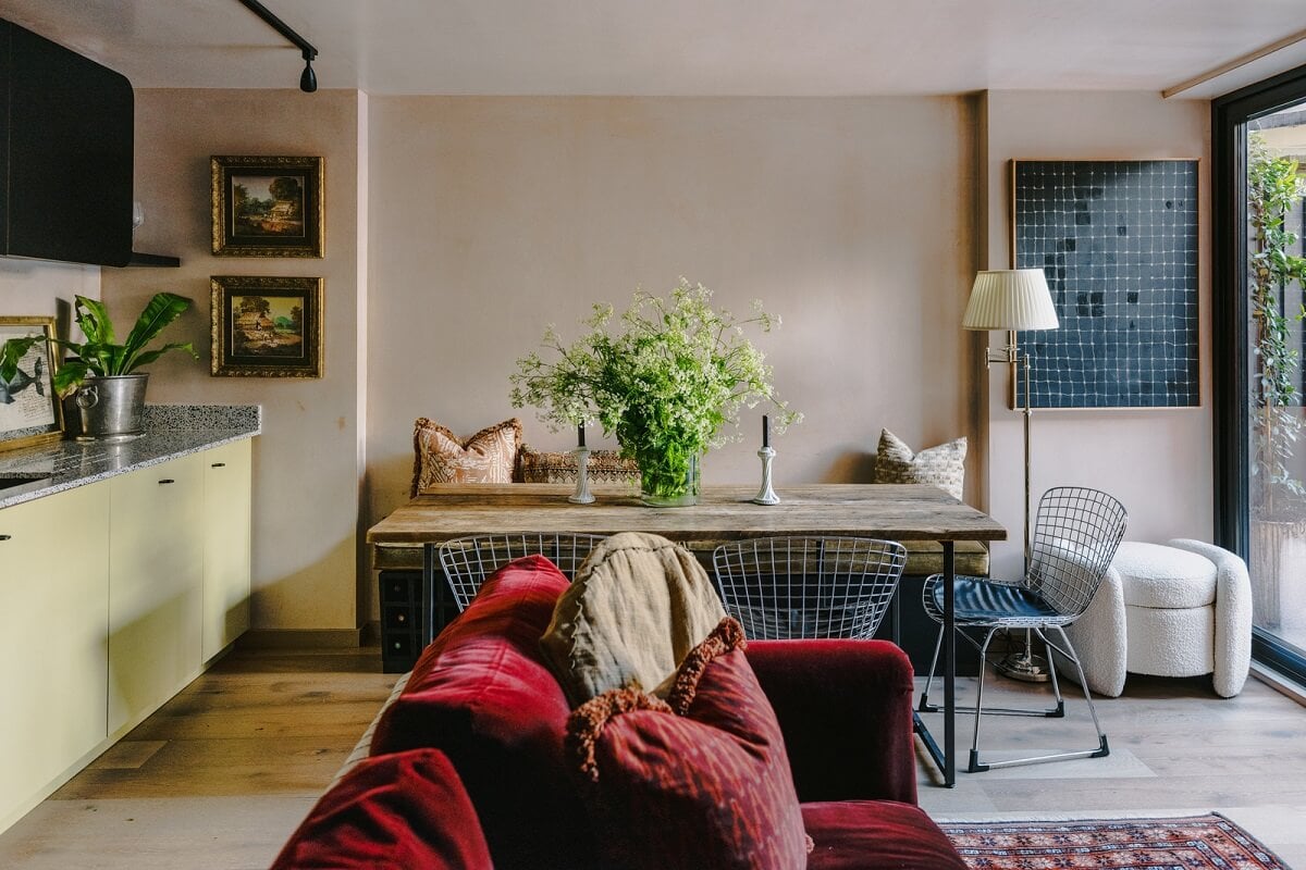 small open plan living room and kitchen with dining tabe and red sofa