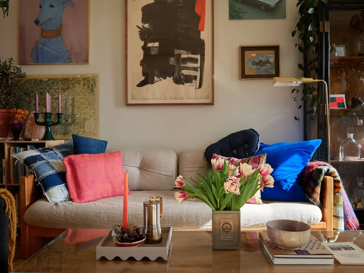 A Swedish Apartment with a Restored Original Kitchen 2 sofa colorful cushions