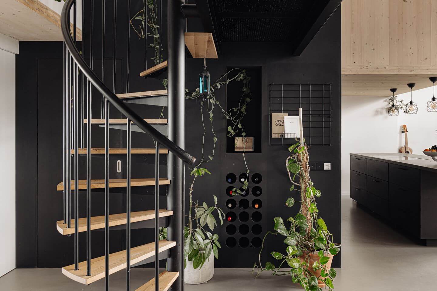 A Modern Loft-Style School Conversion in Amsterdam 15 spiral staircase and black feature wall