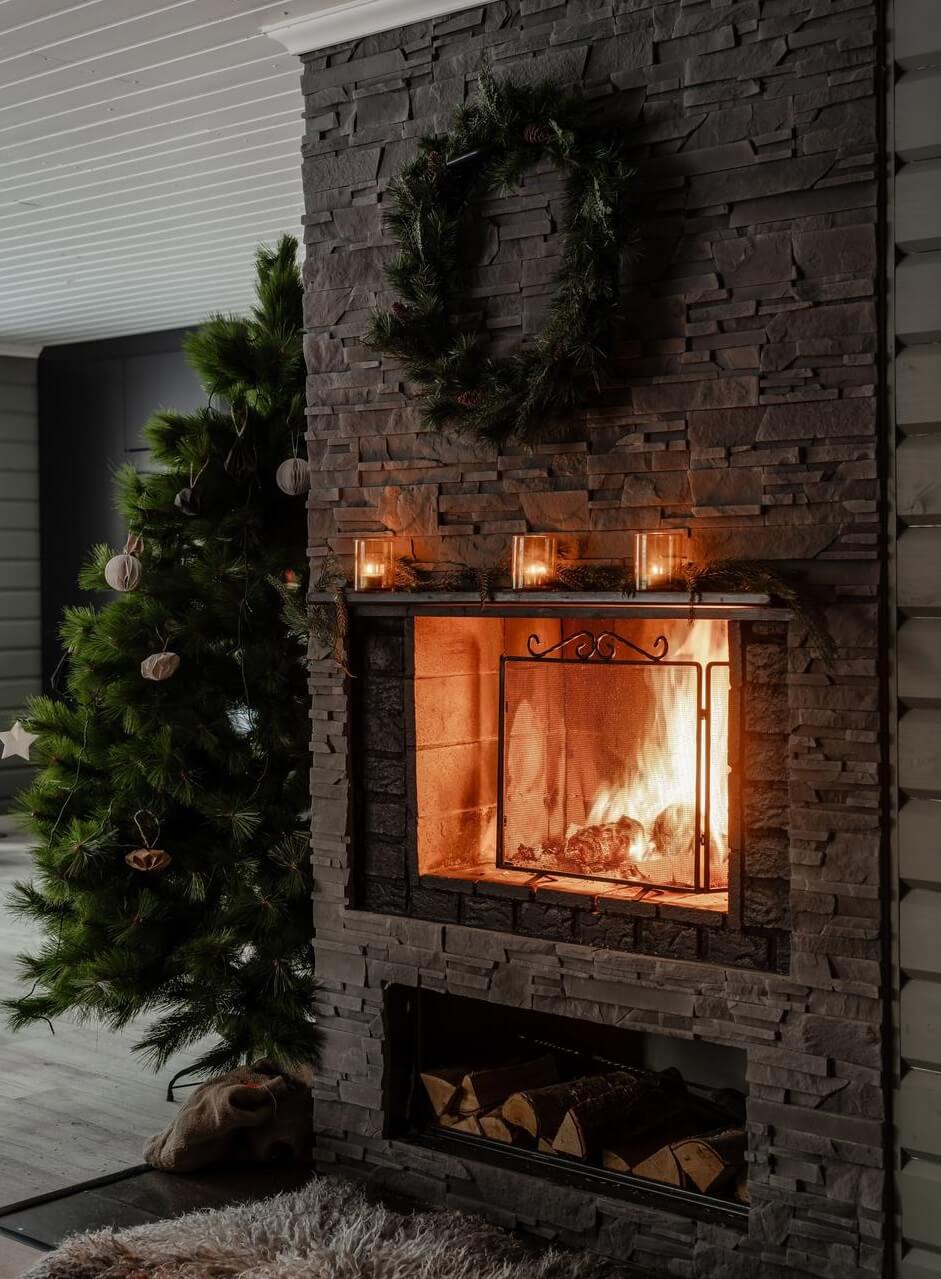 A Gray Swedish Log House Decorated for Christmas 2 stone fireplace with christmas decor nordroom