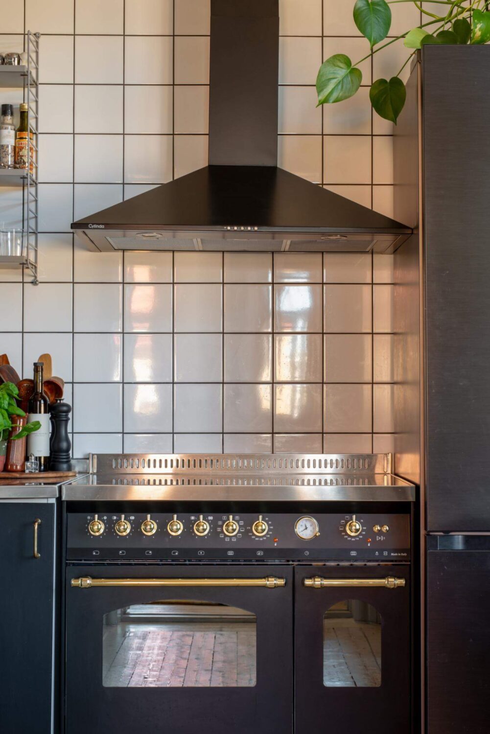 A Corner Apartment with an Industrial Style Kitchen 2 stove with white tiles