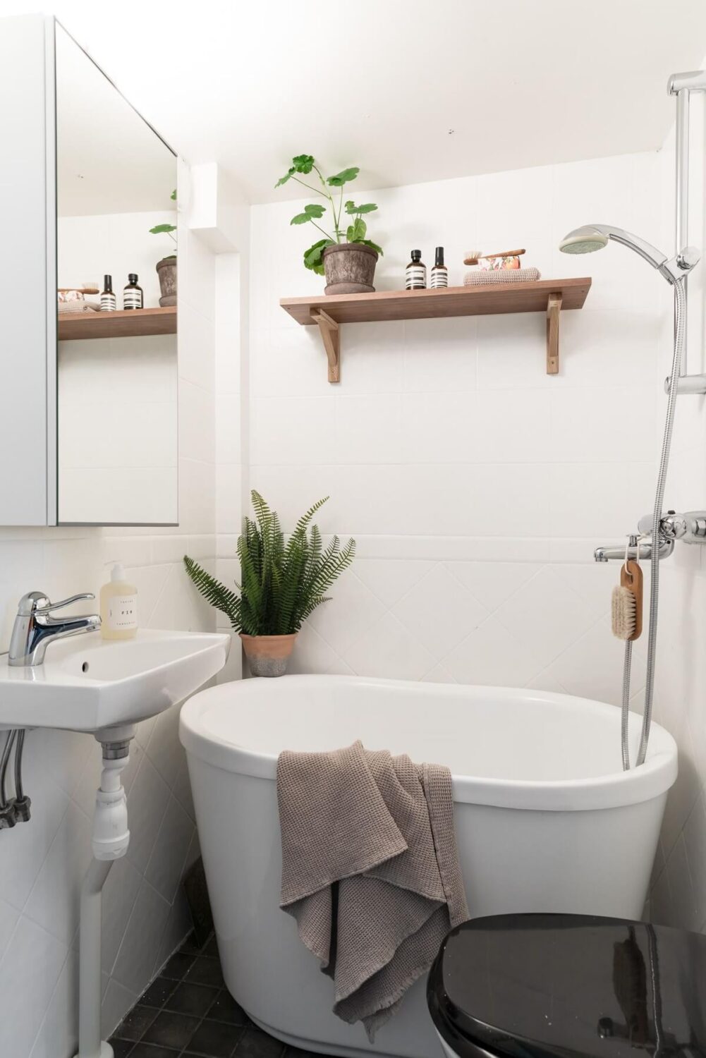 A Swedish Duplex with a Unique Wood and Pastel Colored Kitchen 23 tiny bathroom with bath