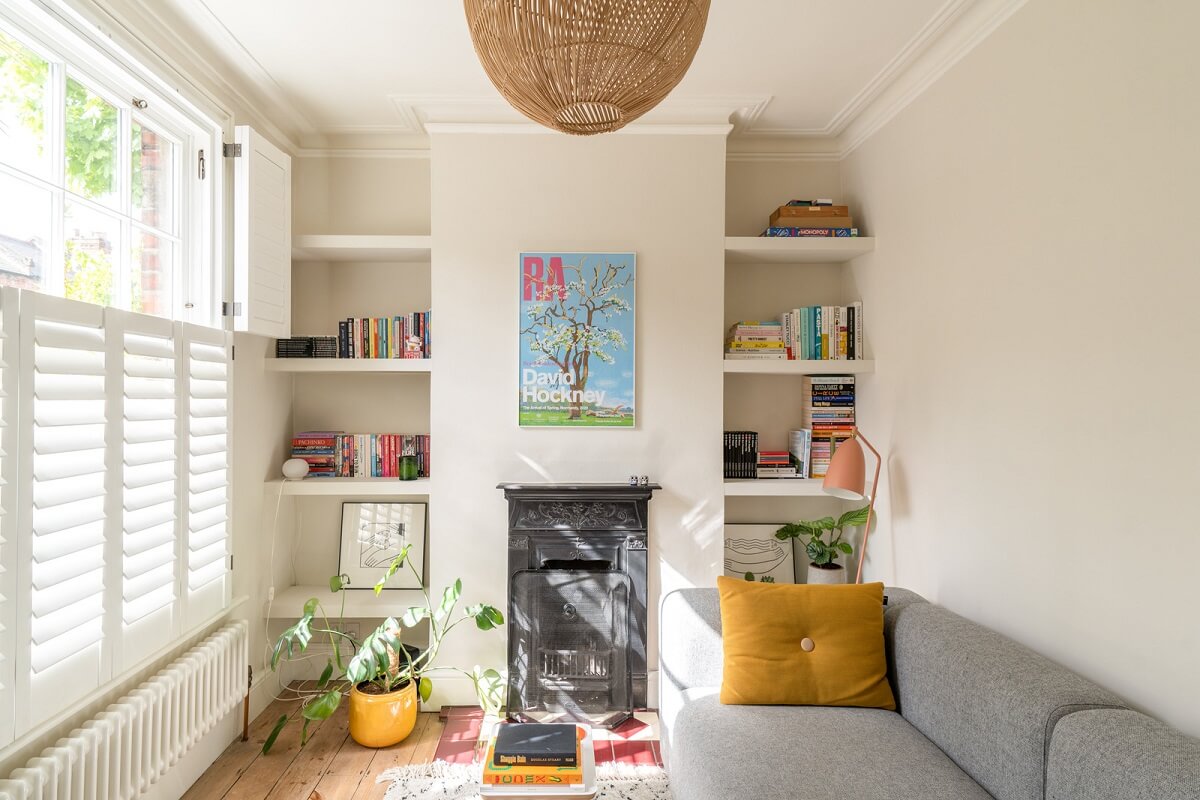 A Tiny Maisonette with Original Details in London 1 tiny living room with fireplace and built in shelves