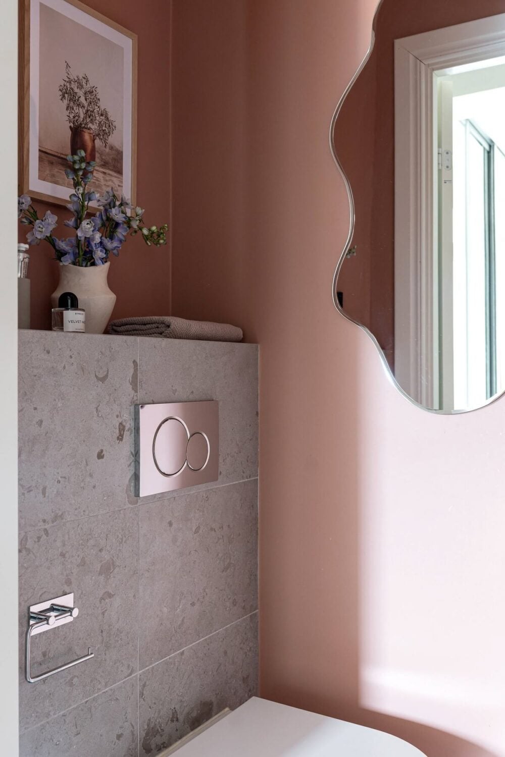 A Stylish Renovated Stockholm Apartment with Built-In Storage 21 toilet with light pink walls