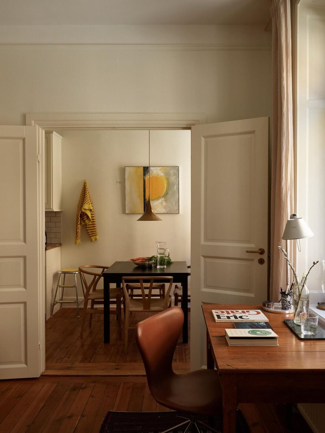 Warm Tones and a Blue Hallway in a Stockholm Apartment 8 view into kitchen