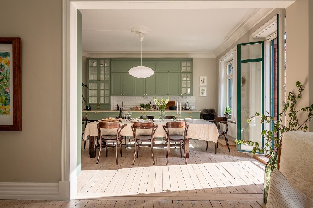 A Turn of the Century Apartment with a Green Kitchen 6 view into kitchen with green cupboards