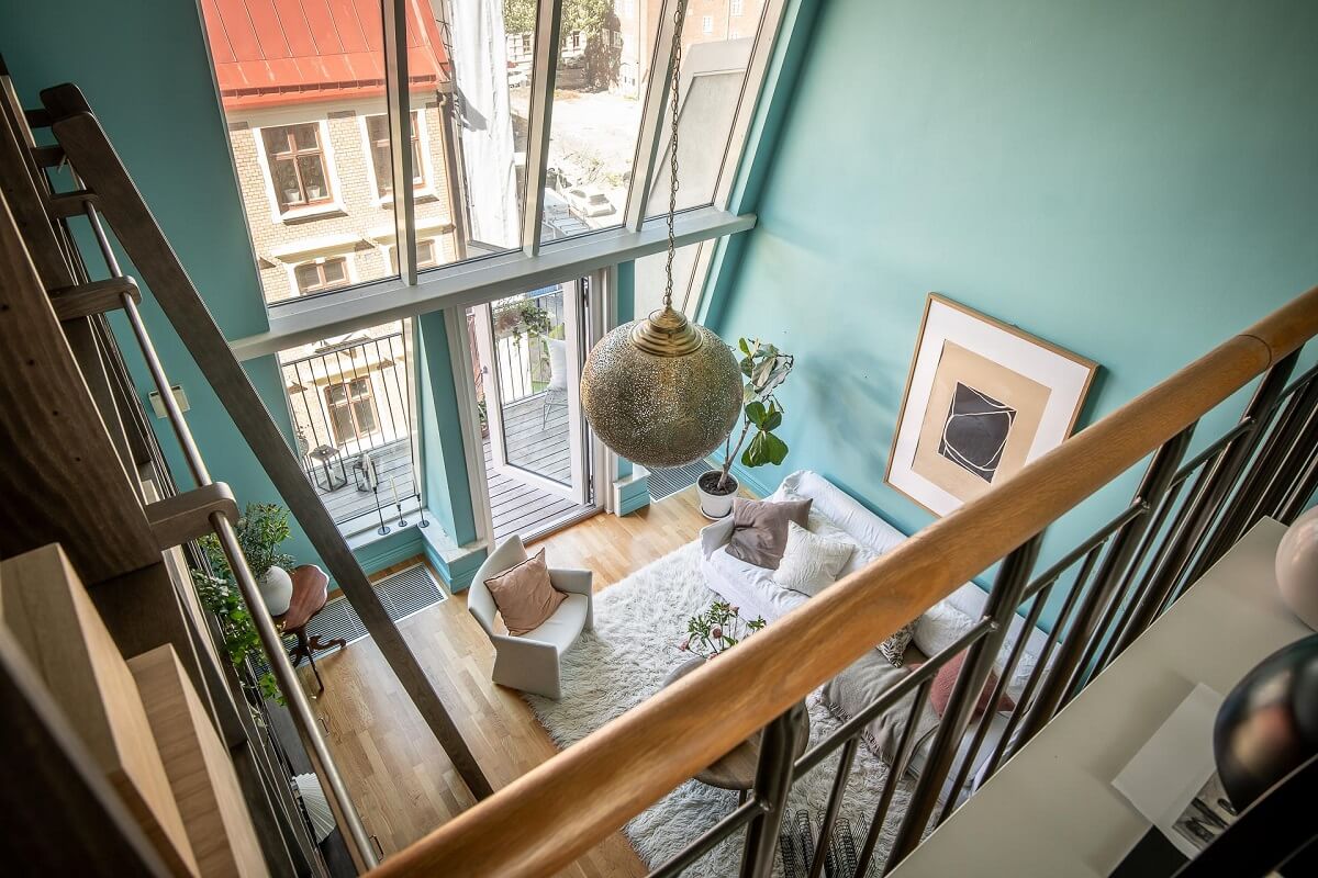 Floor-to-Ceiling Bookcases and Windows in a Loft Style Apartment 9 view into living room