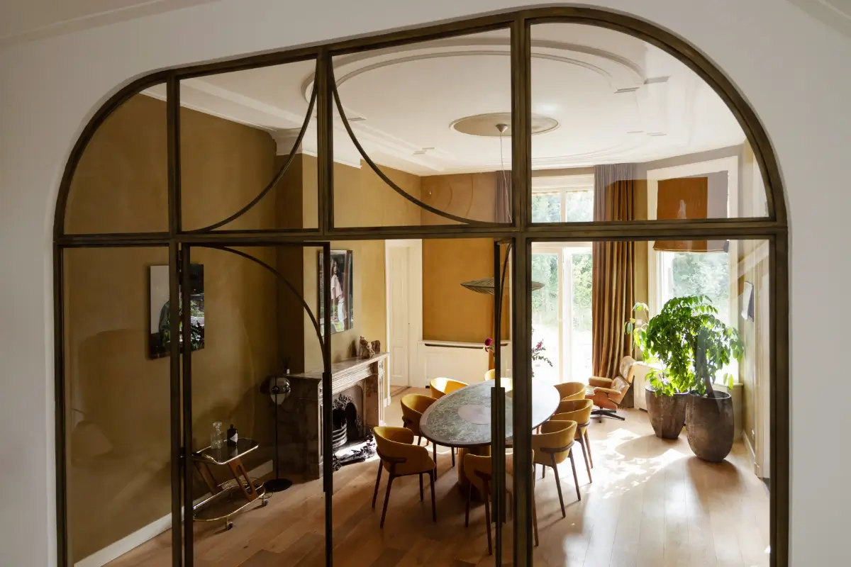A Warm Atmosphere in a Historic Dutch Villa 4 view-into-ochre-dining-room