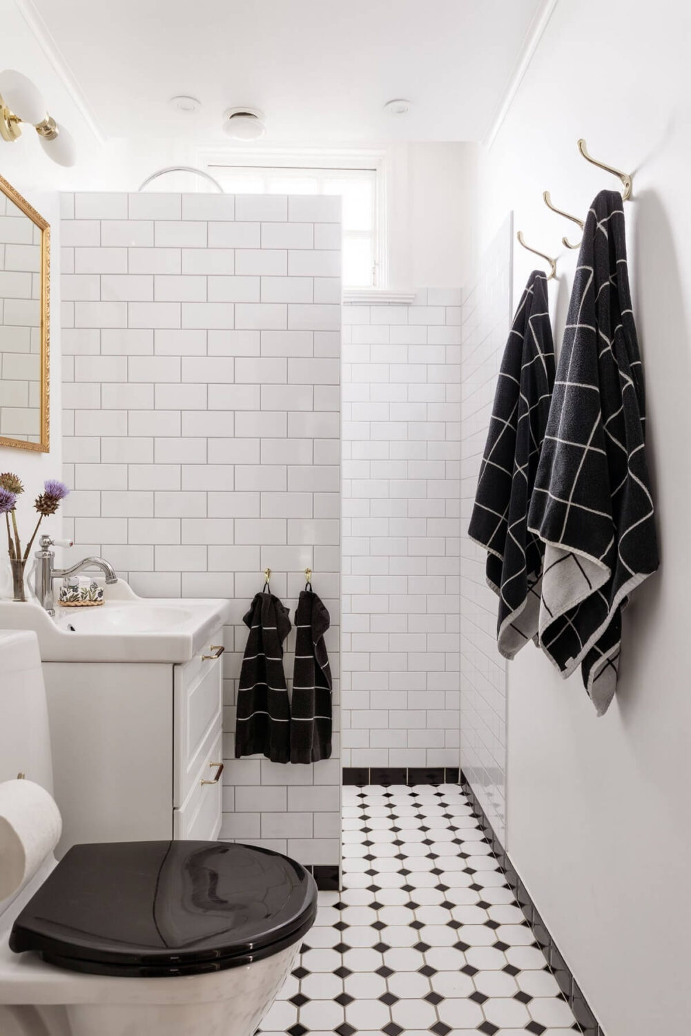 A Swedish Duplex with a Unique Wood and Pastel Colored Kitchen 18 white bathroom with black and white floor tiles nordroom
