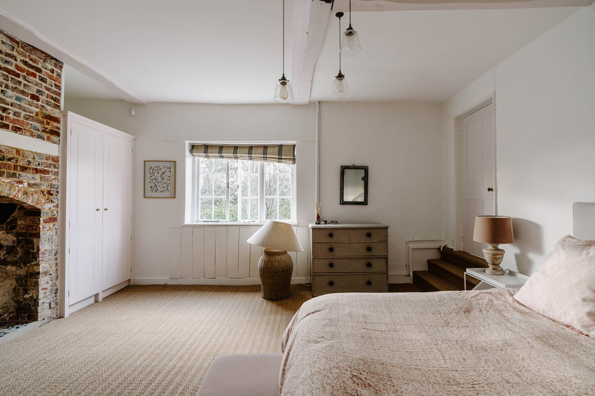 An 18th-Century Historic House with an Amazing Kitchen 16 white bedroom with brick fireplace
