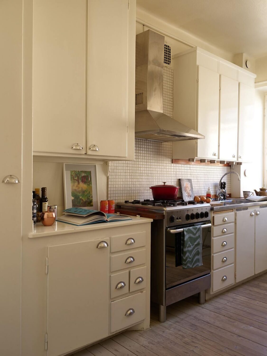 A Vintage Apartment with a Vibrant Blue Bedroom 11 white kitchen