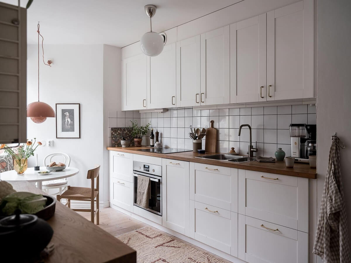 A Light Two Bedroom Apartment in Gothenburg 18 white kitchen cabinets
