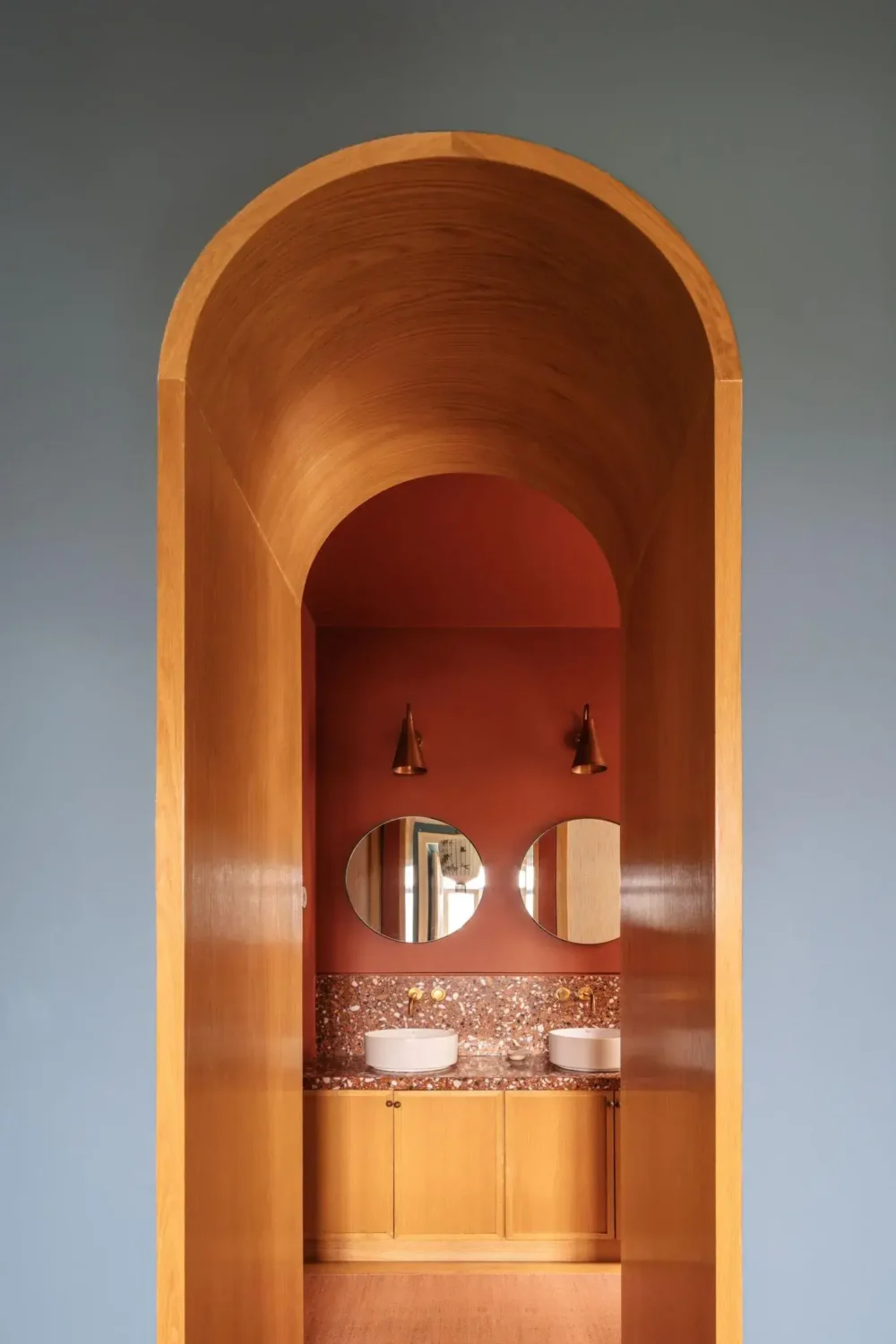 Color Touches in a Design Apartment in a Historic Villa 9 wooden arch into terracotta bathroom nrodroom