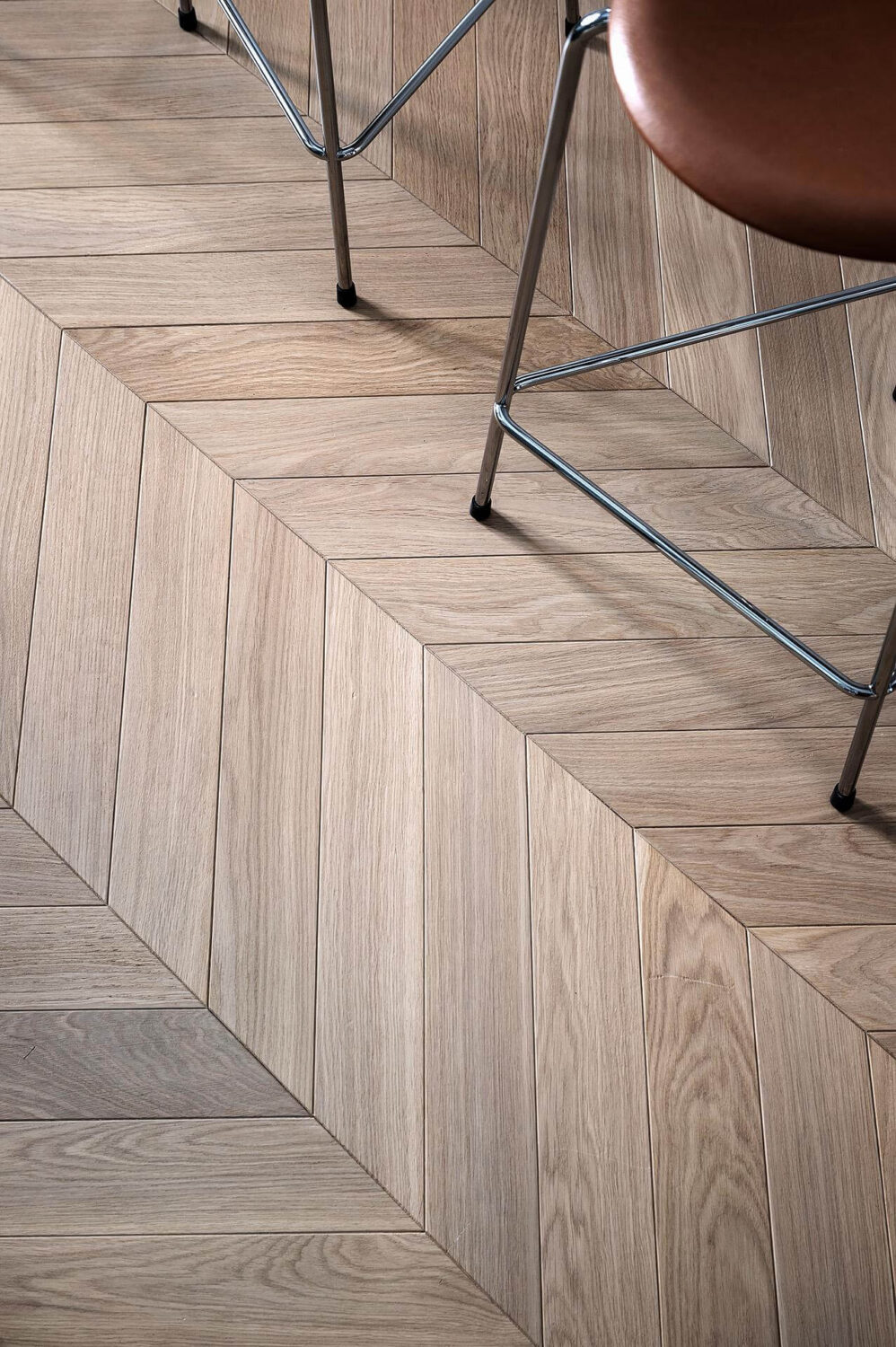A Luxurious Renovated Apartment with Dark Gray Walls 12 wooden chevron floor
