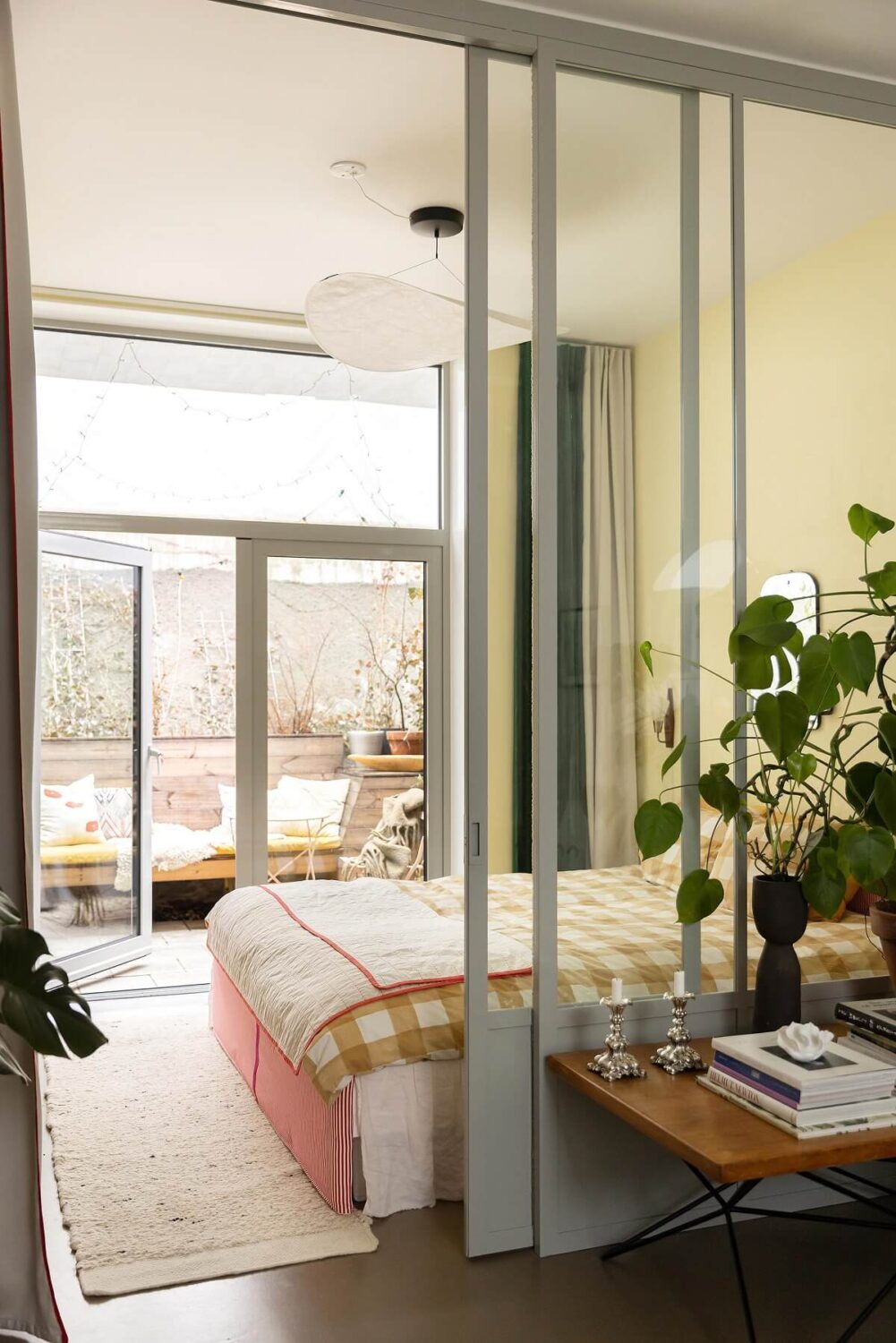 A Unique Basement Apartment in Stockholm 6 yellow bedroom with balcony and glass wall nordroom